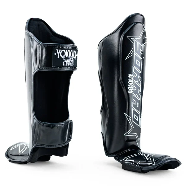 Yokkao Institution Shin Guards - Black in Black — flat lay