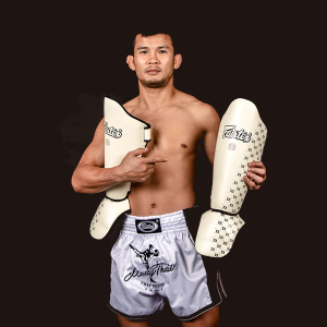 Thai Fighter holding the Fairtex SP5 Shin Protection