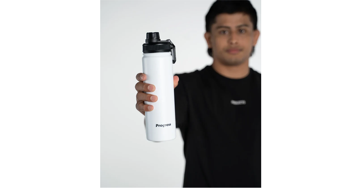 Athlete displaying a white Progress water bottle