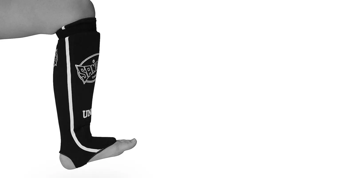 Sandee black slip-on cotton shin guards for Muay Thai, MMA and kickboxing.
