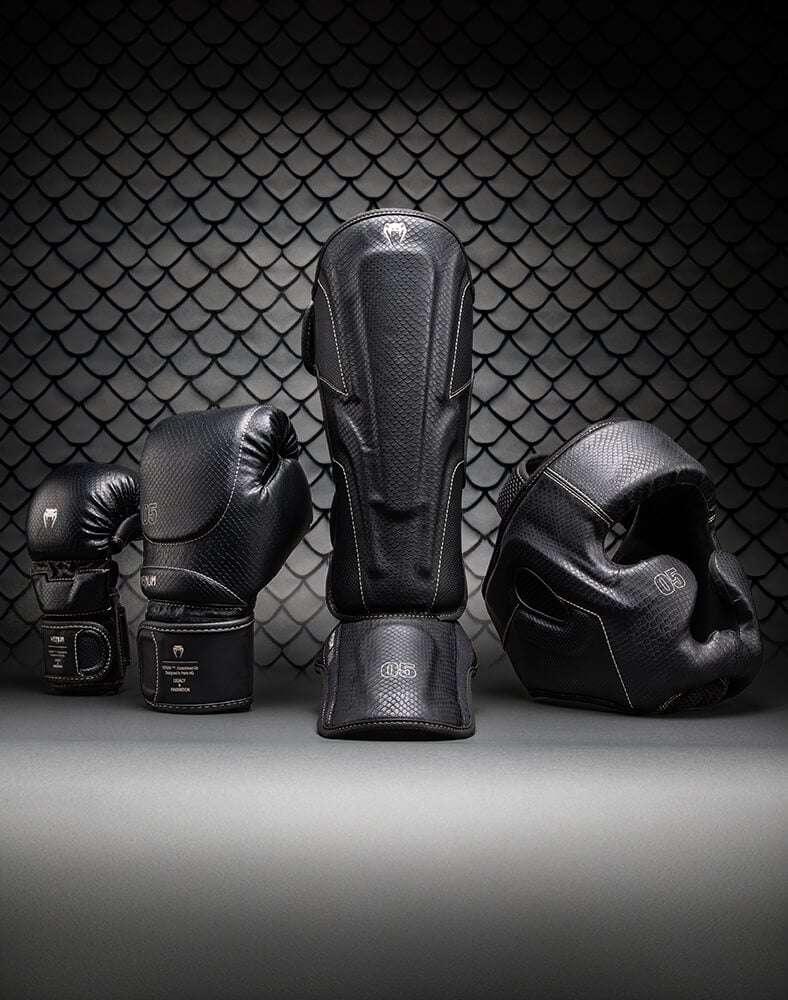 An image of the Venum Impact Evo, Boxing Gloves, Shinguards and Head Guard in Black